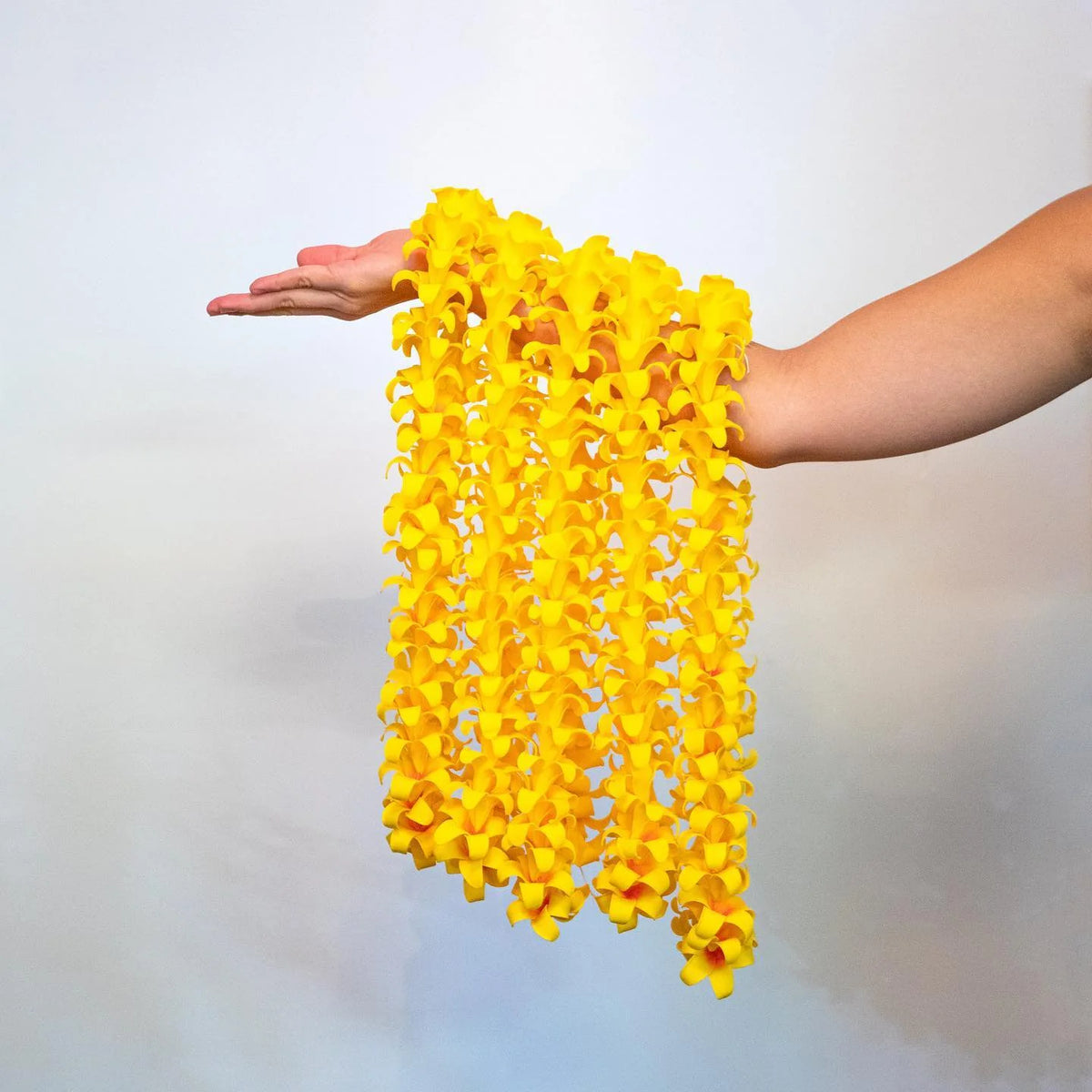 Yellow soft foam Puakenikeni leis grouped for event or wholesale ordering